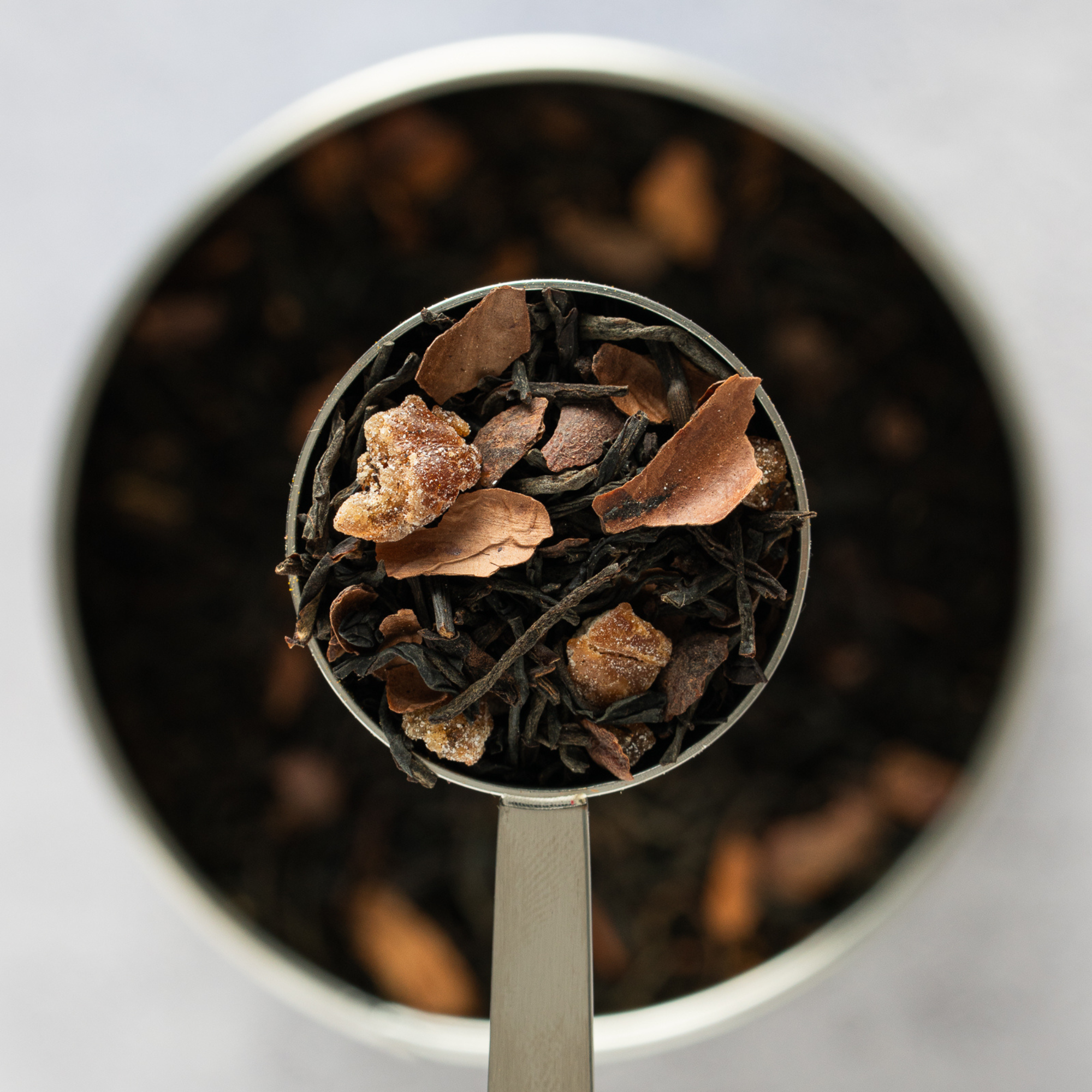Close up of Biscuit Break loose leaf black tea with cocoa shells and date pieces