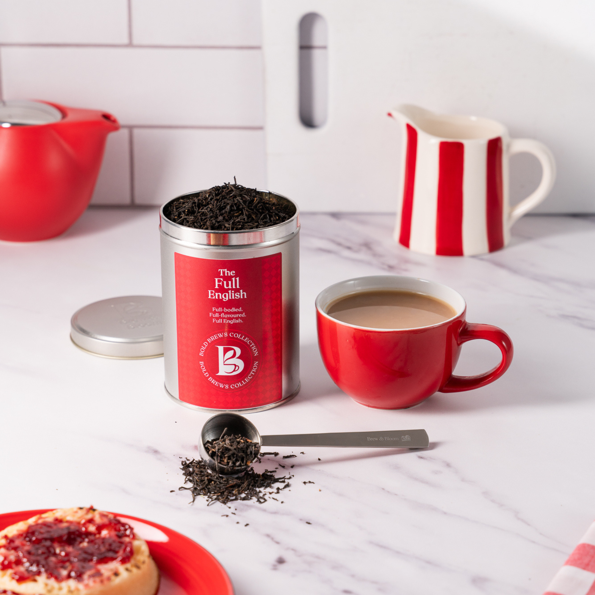 The Full English loose leaf black tea tin with red mug on kitchen counter