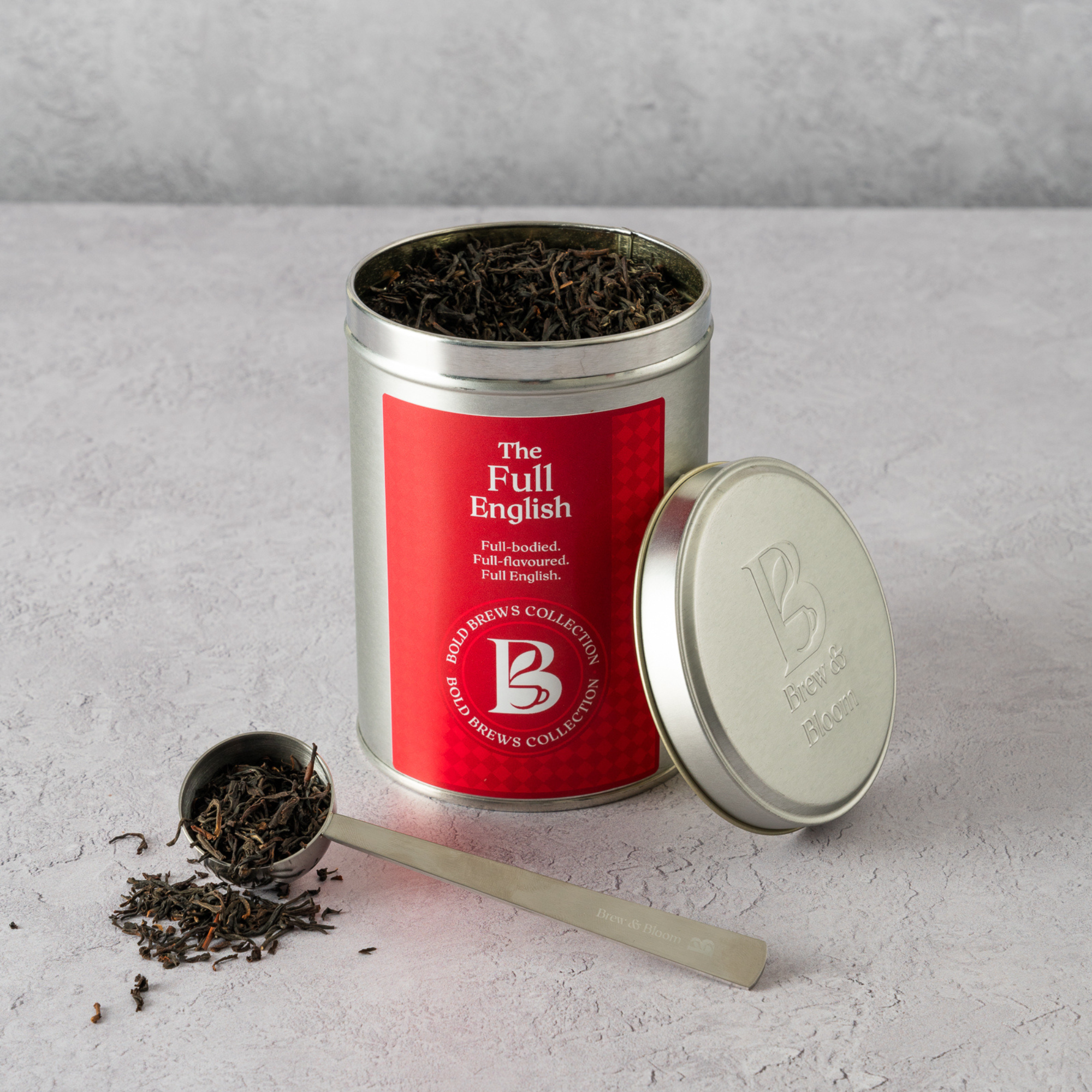 The Full English loose leaf black tea tin with red mug on kitchen counter