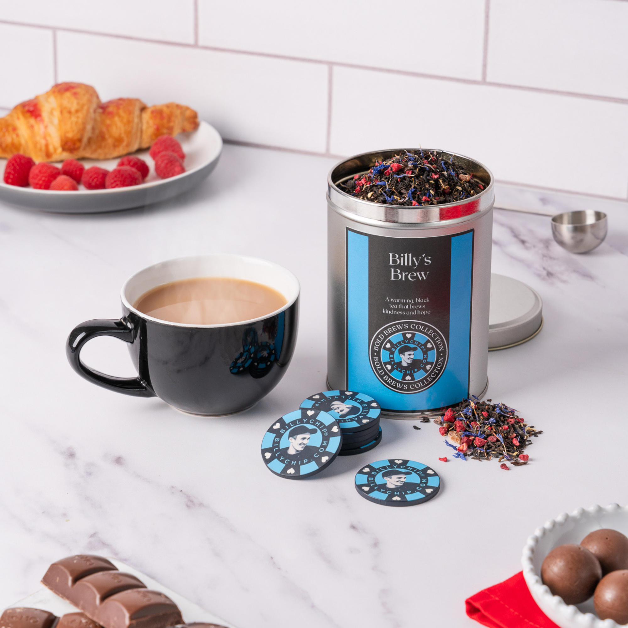 Billy’s Brew loose leaf black tea tin with cup and BillyChip tokens on kitchen counter