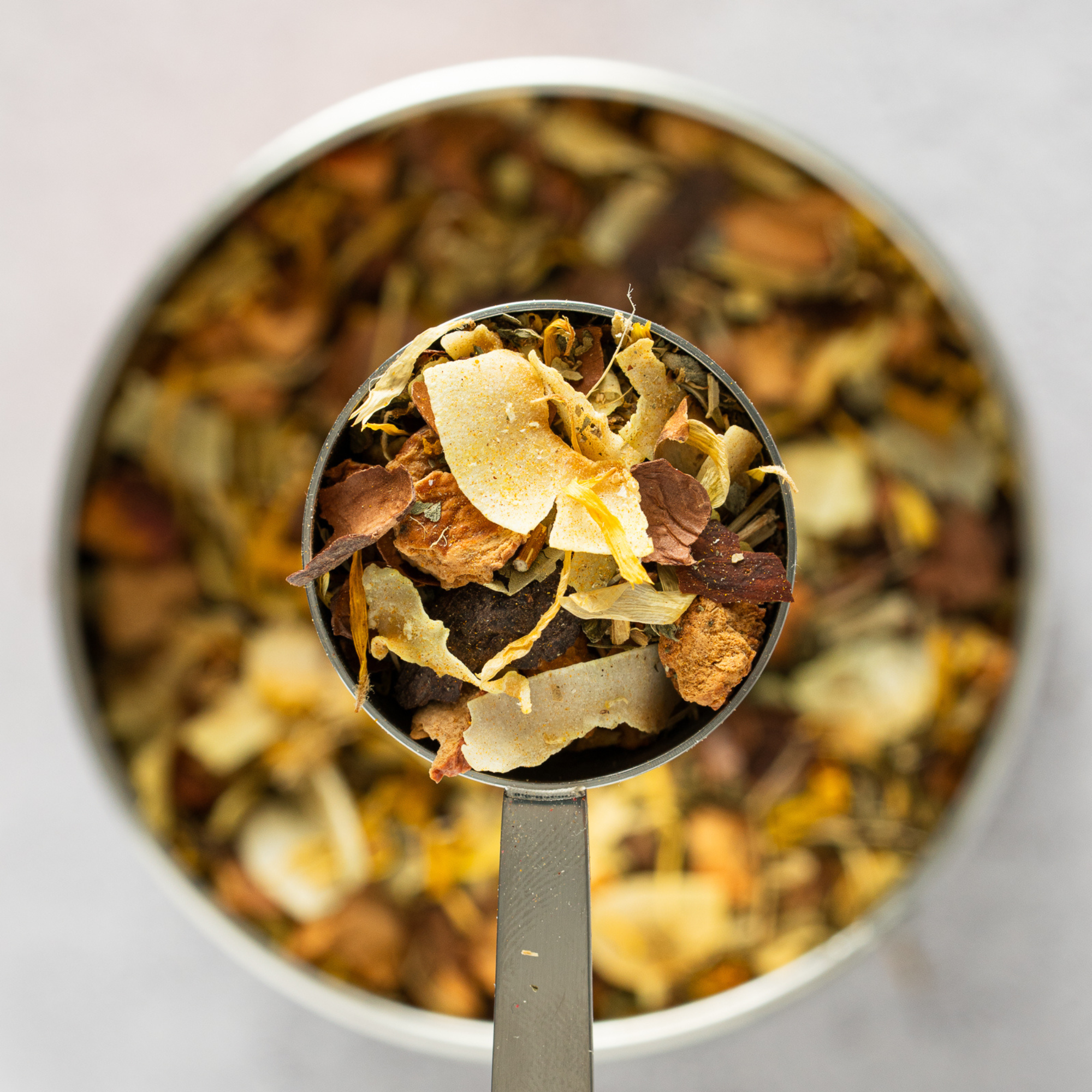 Close up of Blooming Dreamy loose leaf golden turmeric tea with coconut and chocolate notes